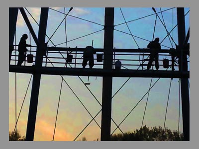 workers on scaffolding during sunset